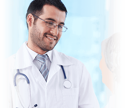 male doctor smiles while listening to patient