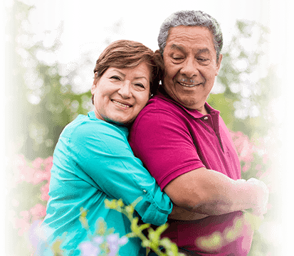 older woman hugging her husband from behind