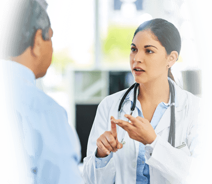 Young female physician speaks to patient