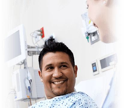 Patient in hospital bed, smiling