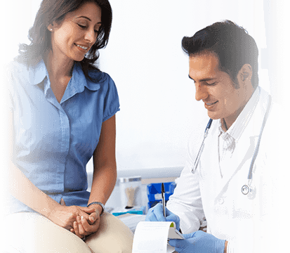 physician taking notes while speaking with patient