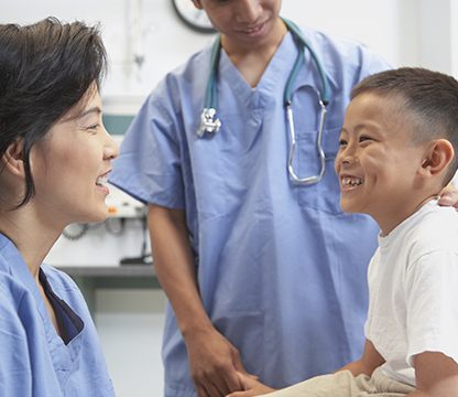 Smiling child with female pediatrician