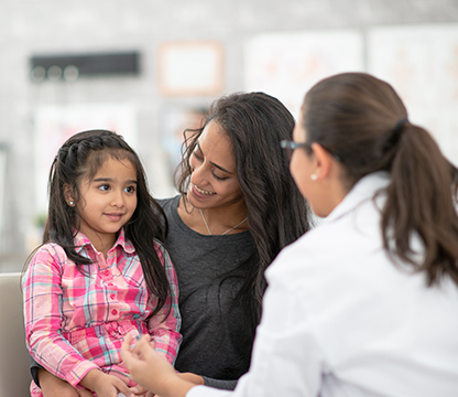 Smiling child with female pediatrician