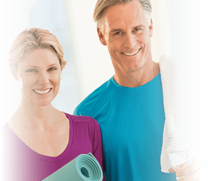 Older couple smiles before yoga class