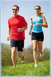 Couple running on a grassy hill